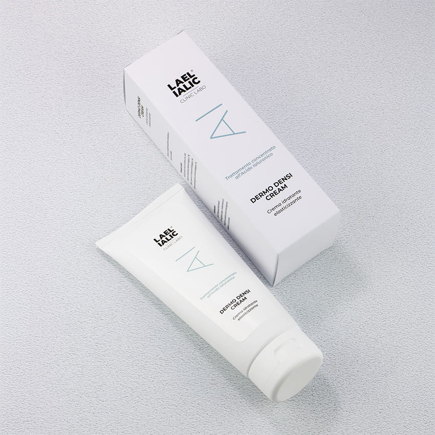 Crema Dermo Densi Lael Ialic con confezione e tubo bianco elegantemente disposti su sfondo chiaro. Il prodotto è descritto come crema idratante elasticizzante con trattamento concentrato all’acido ialuronico, pensato per migliorare la compattezza e l’elasticità della pelle.